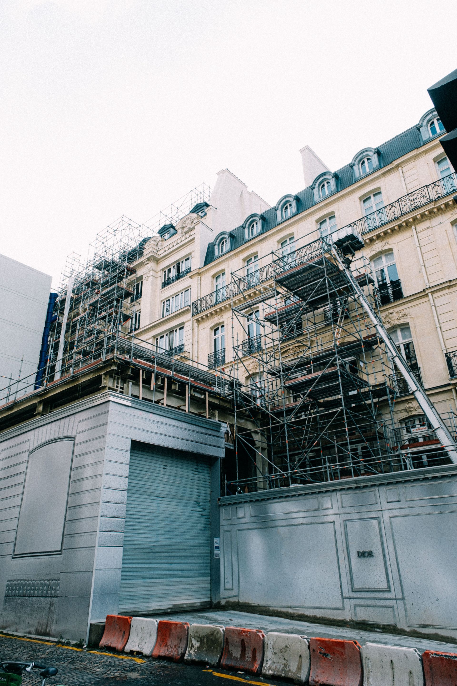 A historic building with scaffolding undergoing renovation in an urban area.